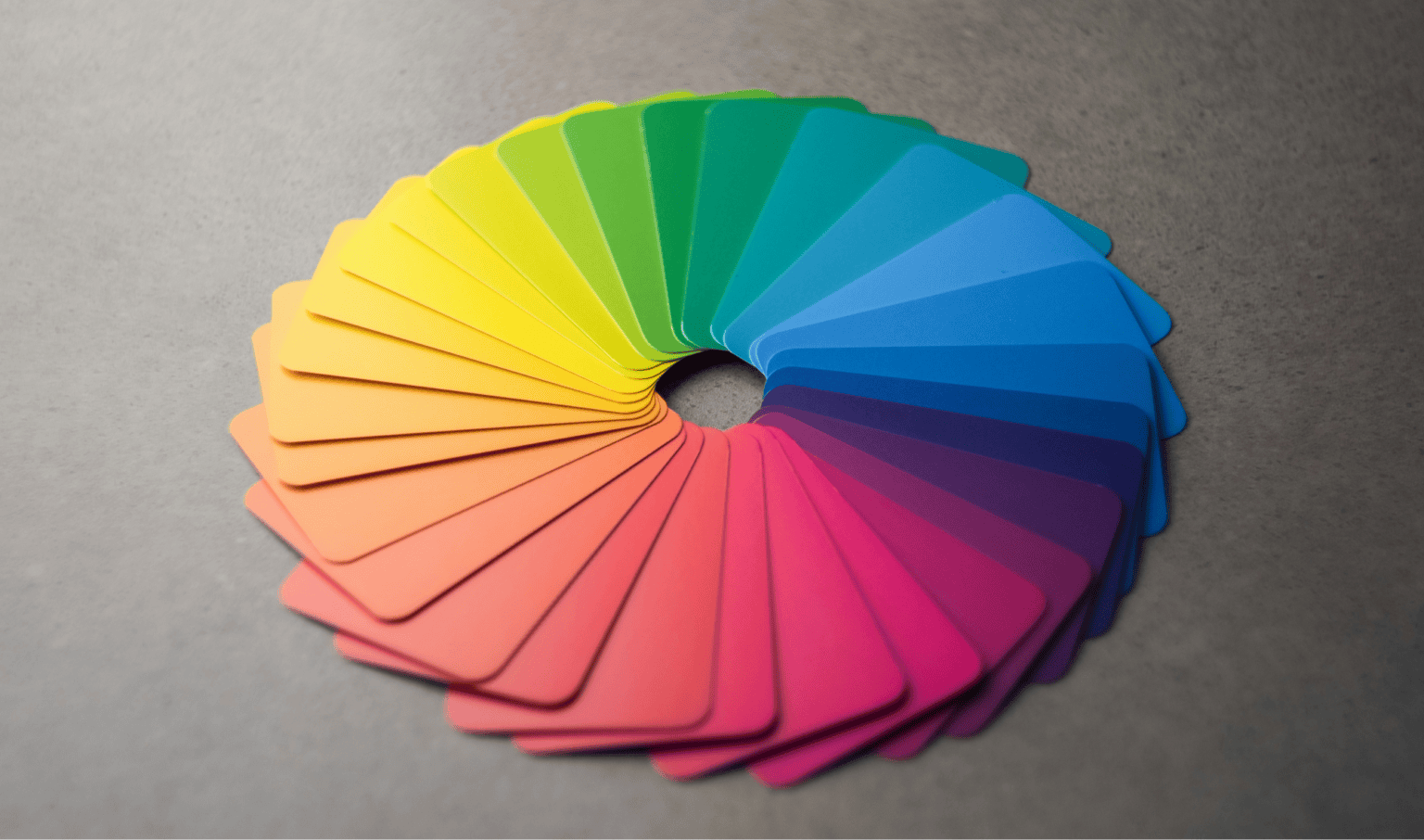 A vibrant color wheel displaying a spectrum of colors from yellow to pink, used for color theory and design inspiration.