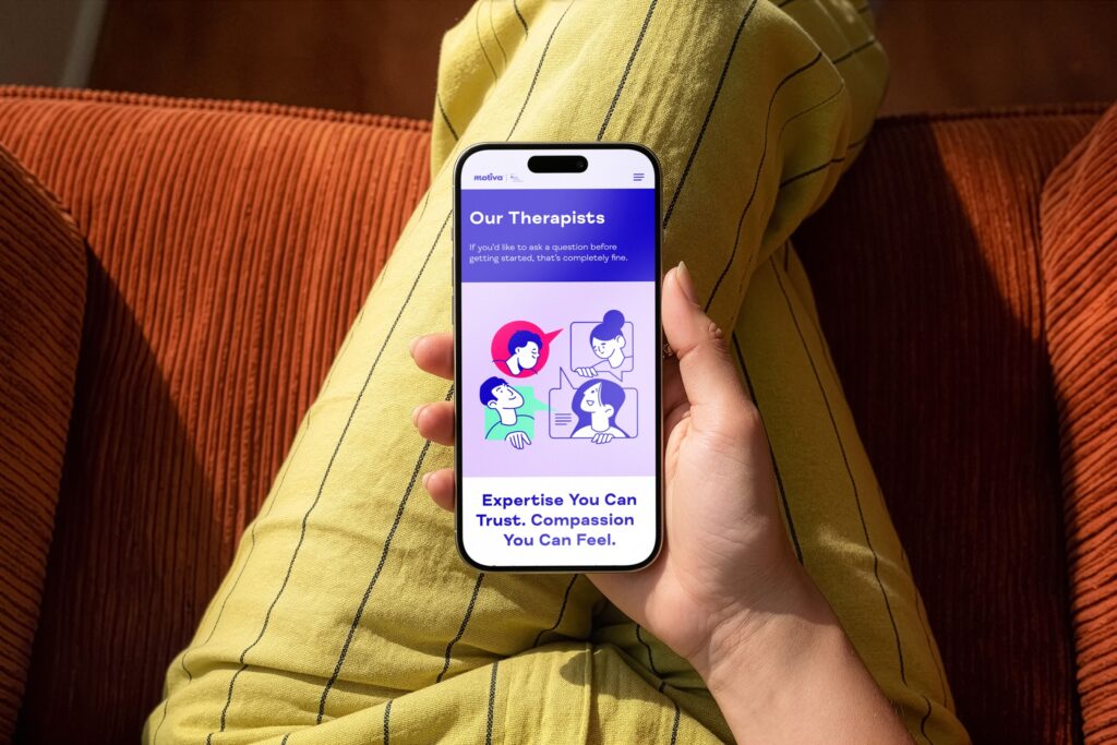 Mobile phone displaying therapy app with illustrations of therapists, showcasing web design for health services in Hull, Yorkshire.
